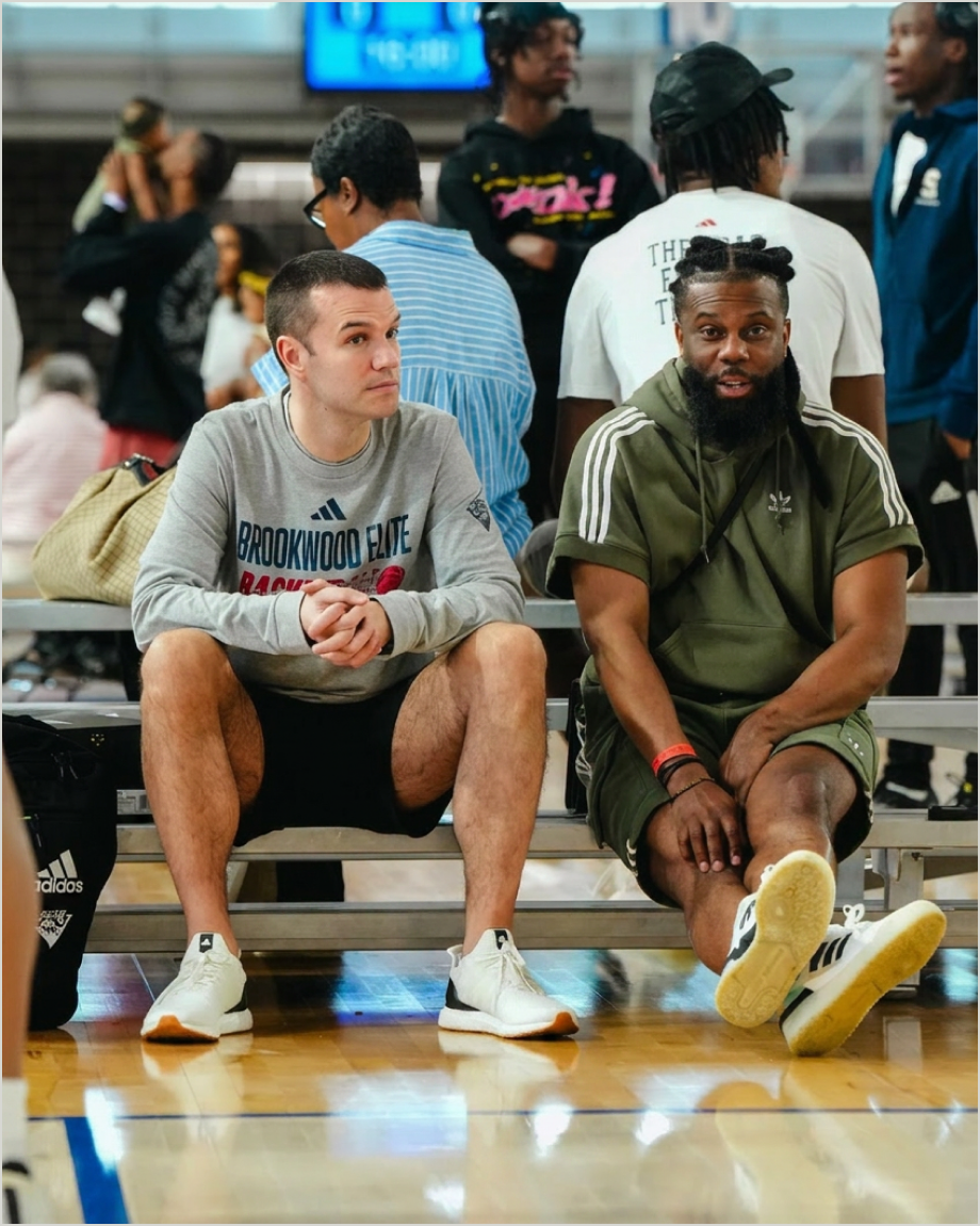 Joey and Nelson courtside at a basketball event